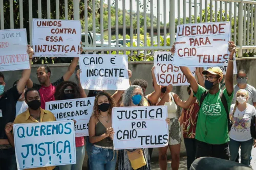 Familiares e amigos mostram cartazes na frente do fórum, no Colubandê