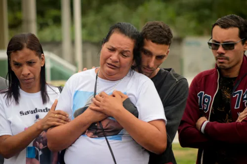 Mãe do jovem precisou ser amparada por familiares durante o cortejo